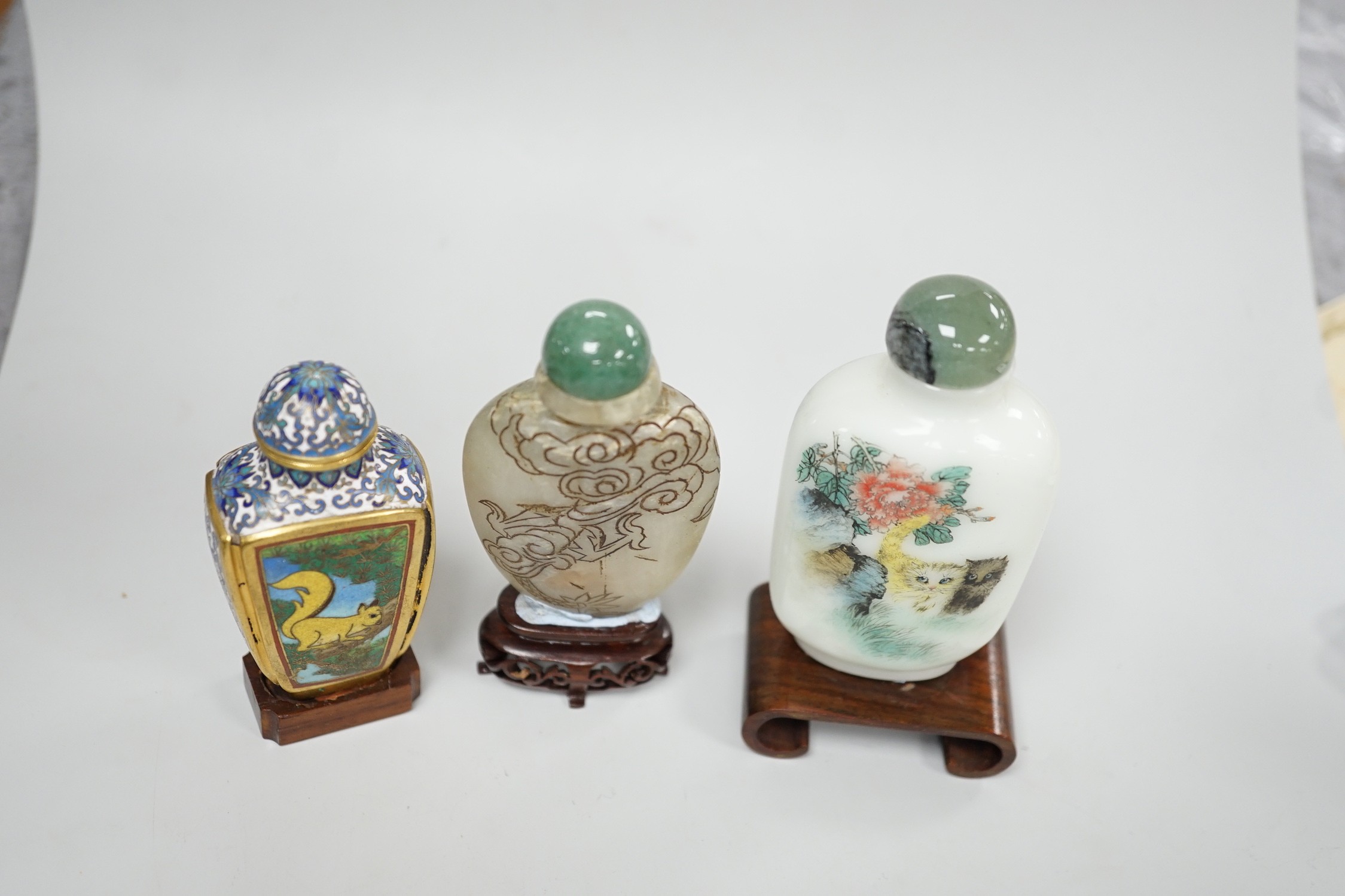 A Chinese cloisonné enamel snuff bottle, enamelled glass and stone snuff bottles. Tallest 8cm (3)